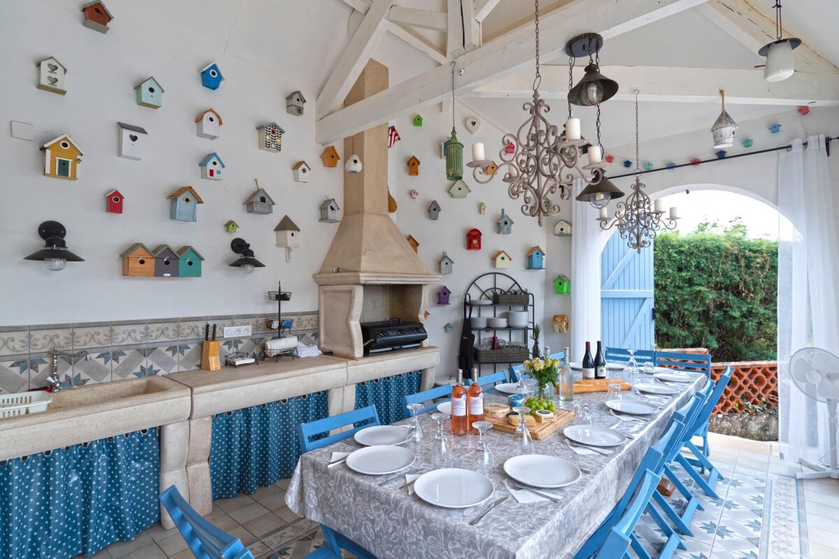 A dining room table with plates and wine bottles on it