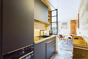 A kitchen with a sign that says white management on it