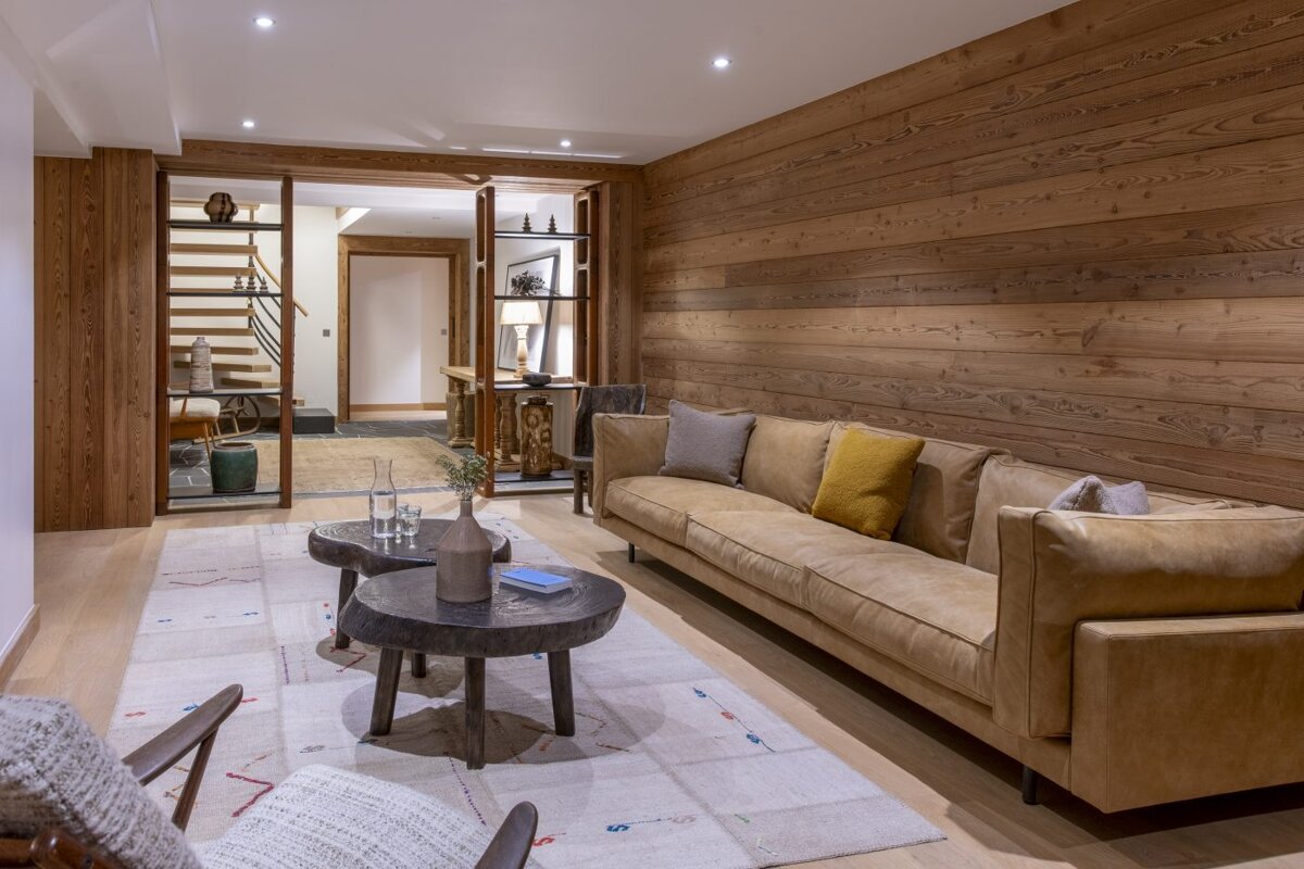 A living room with a couch and two tables