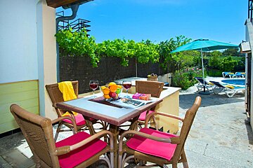 A table with a magazine and a bowl of fruit on it