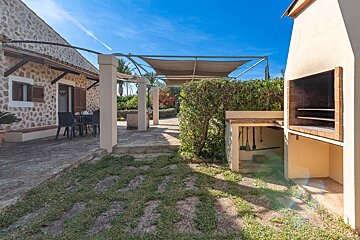 A patio area with a grill and a canopy over it