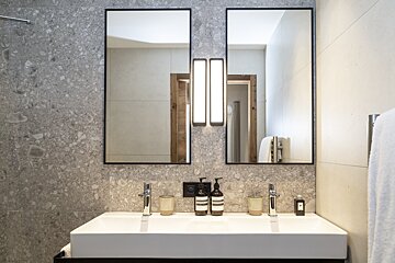 A bathroom with two sinks and two mirrors