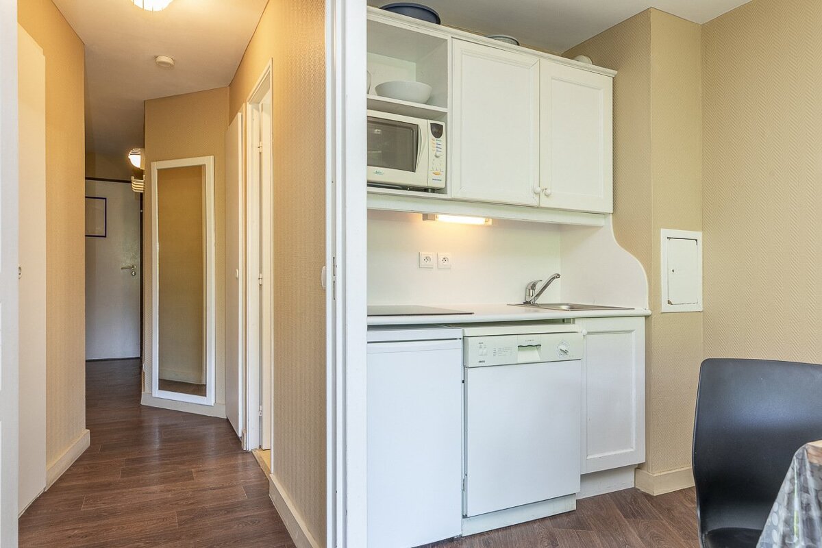 A small kitchen with a microwave and a dishwasher