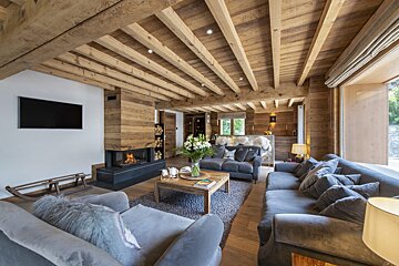 A living room with a fireplace and a flat screen tv