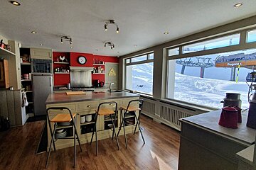 A kitchen with a pepsi sign on the window