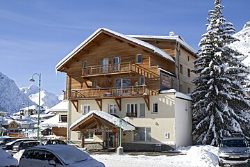 A snowy building with a sign that says