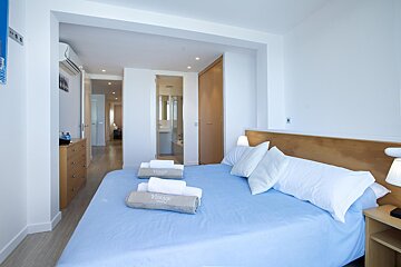 A bedroom with a bed and two towels that say vintage