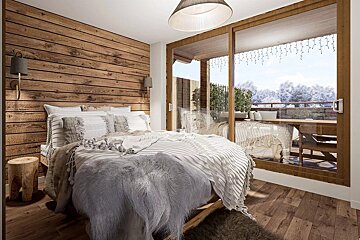 Cozy alpine bedroom featuring a wooden plank wall, plush bed, and glass sliding doors overlooking a snowy winter landscape.