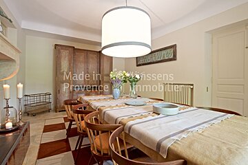 A dining room table with a table cloth that says made in provence