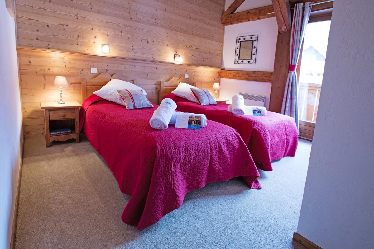 A hotel room with two beds and a sign that says ' hotel ' on it