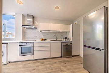 A kitchen with stainless steel appliances and white cabinets