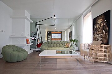 A living room with a green couch and a white coffee table
