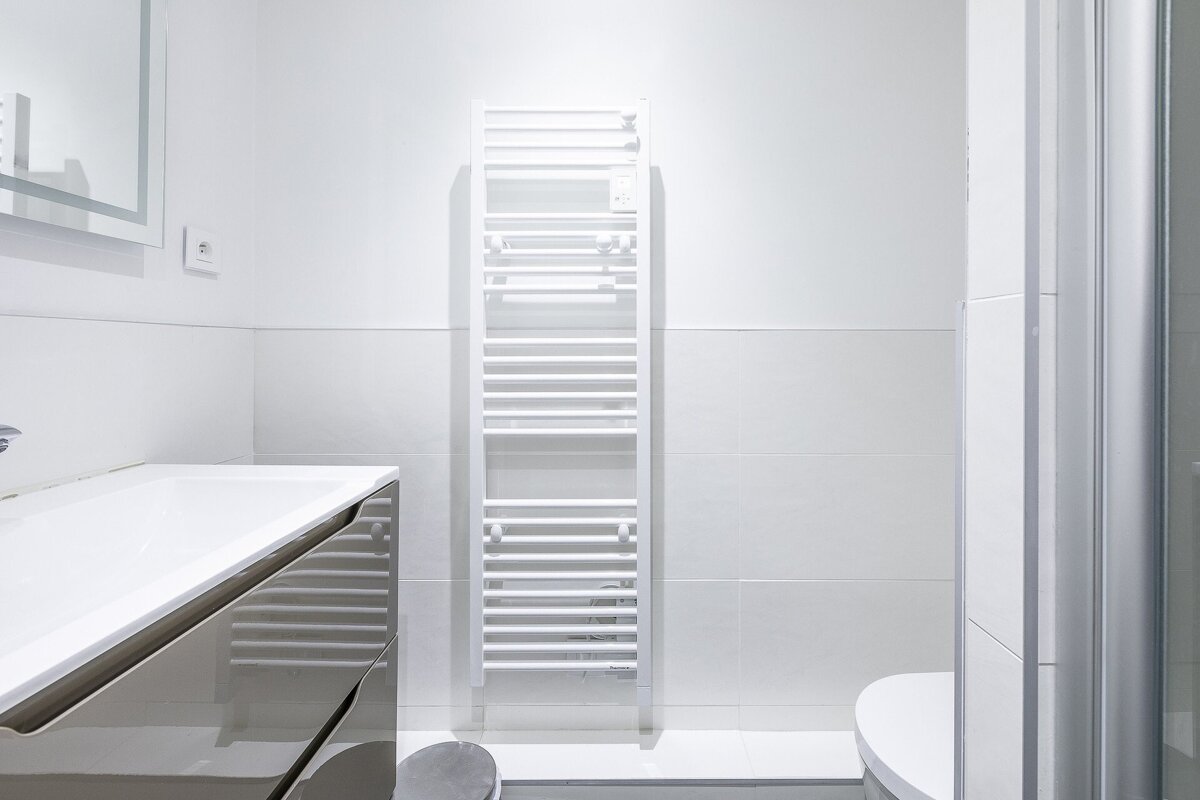 A bathroom with a towel rack and a toilet