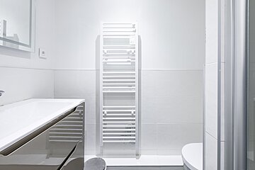 A bathroom with a towel rack and a toilet