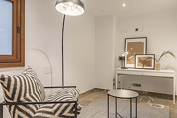 A black and white chair sits in a room next to a desk