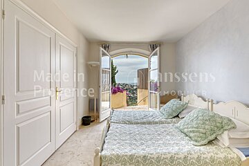 A bedroom with two beds and a sign that says made in provence