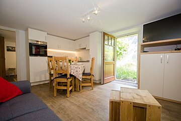 A living room with a table and chairs in it