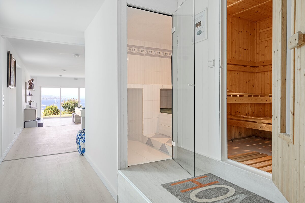 A hallway leading to a sauna and a bathroom