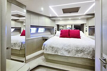 A bedroom with a large bed and pink pillows