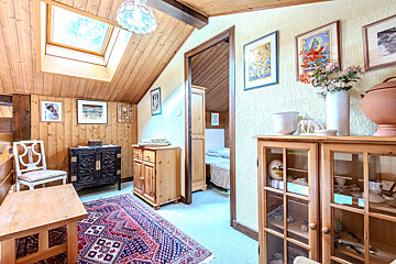 A bedroom with two beds and a skylight in the ceiling