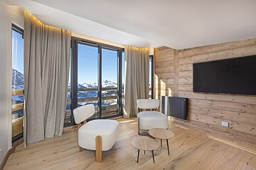 A living room with two chairs and a flat screen tv