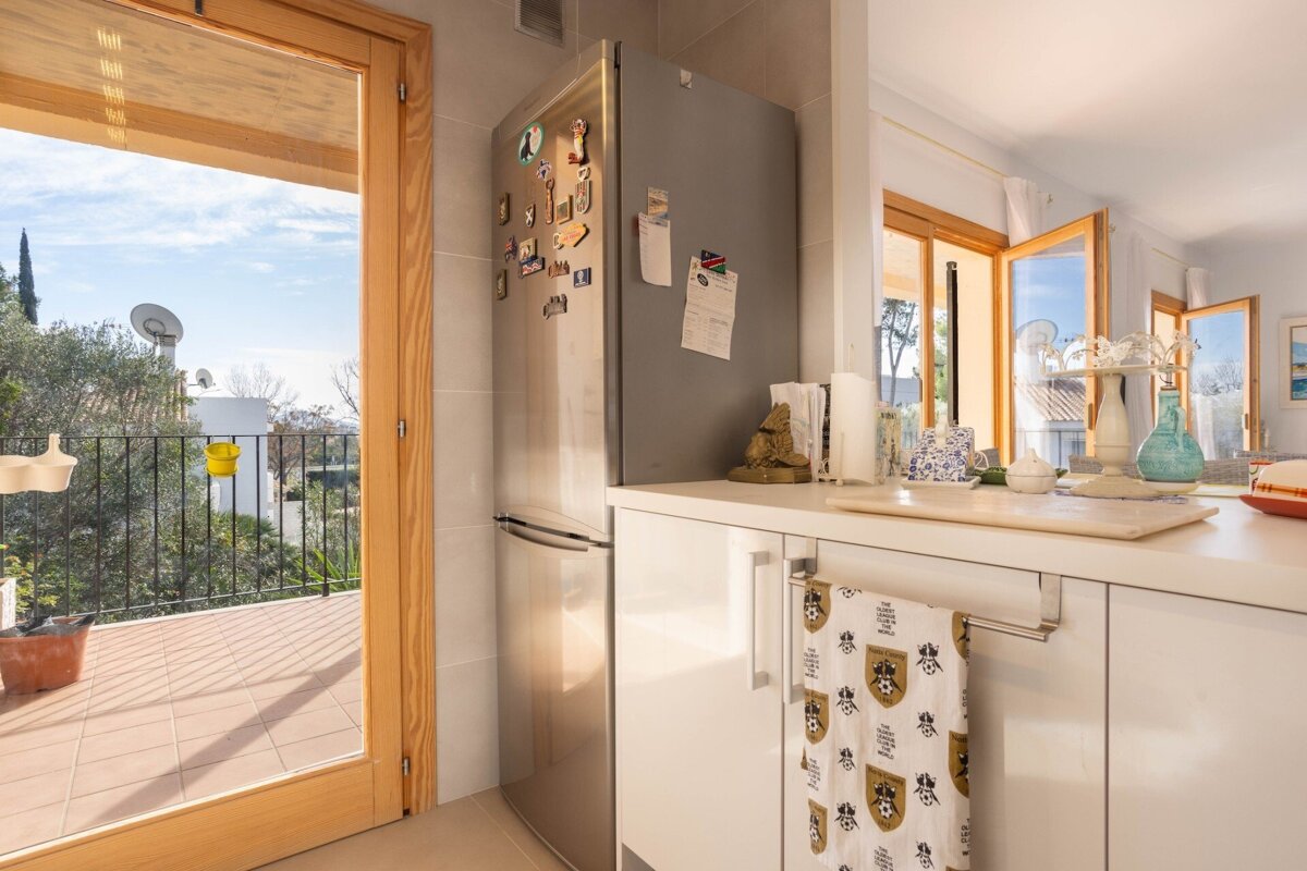 A kitchen with a fridge and a towel that says ' harry potter ' on it