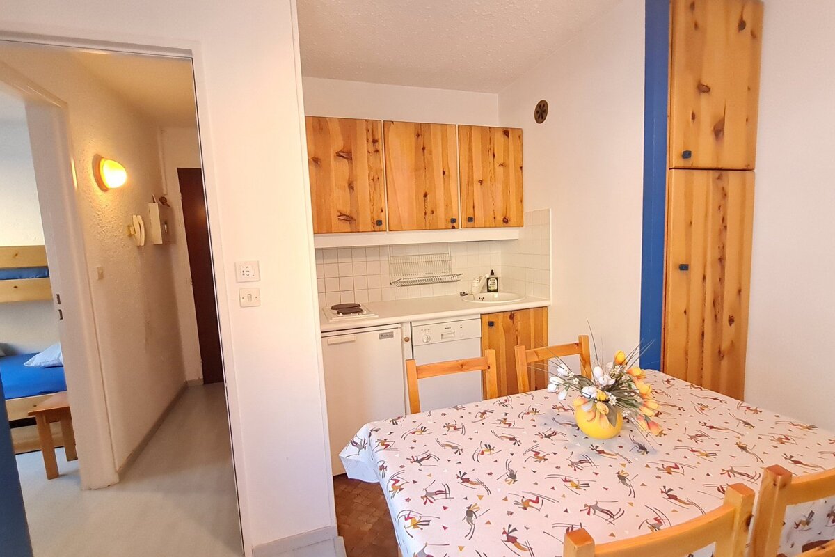 A kitchen with a table and chairs and a dishwasher