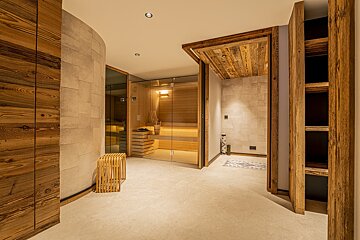 A room with a wooden wall and a glass door