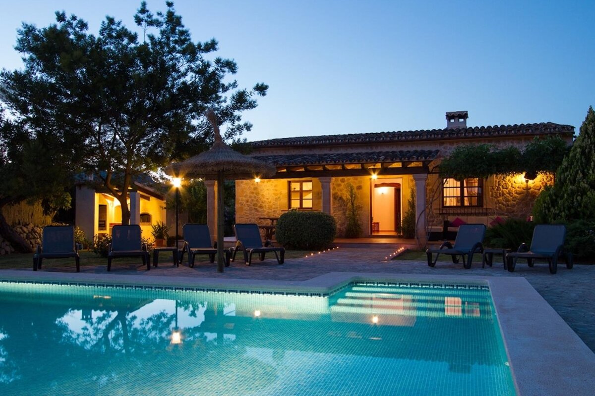 A house with a swimming pool in front of it