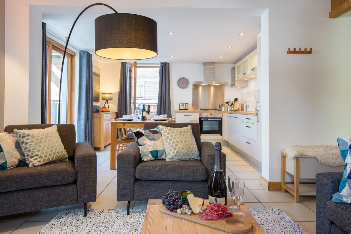 A bottle of champagne sits on a table in a living room