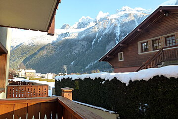 A balcony with a view of snow covered mountains