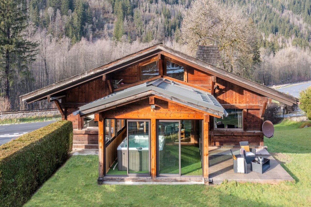 A small wooden house with a hot tub inside of it