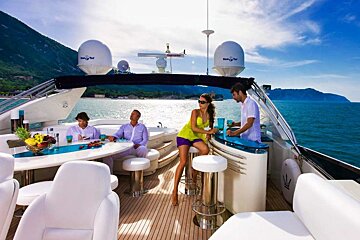 Two men and a woman on a boat with a satellite dish that says seagull