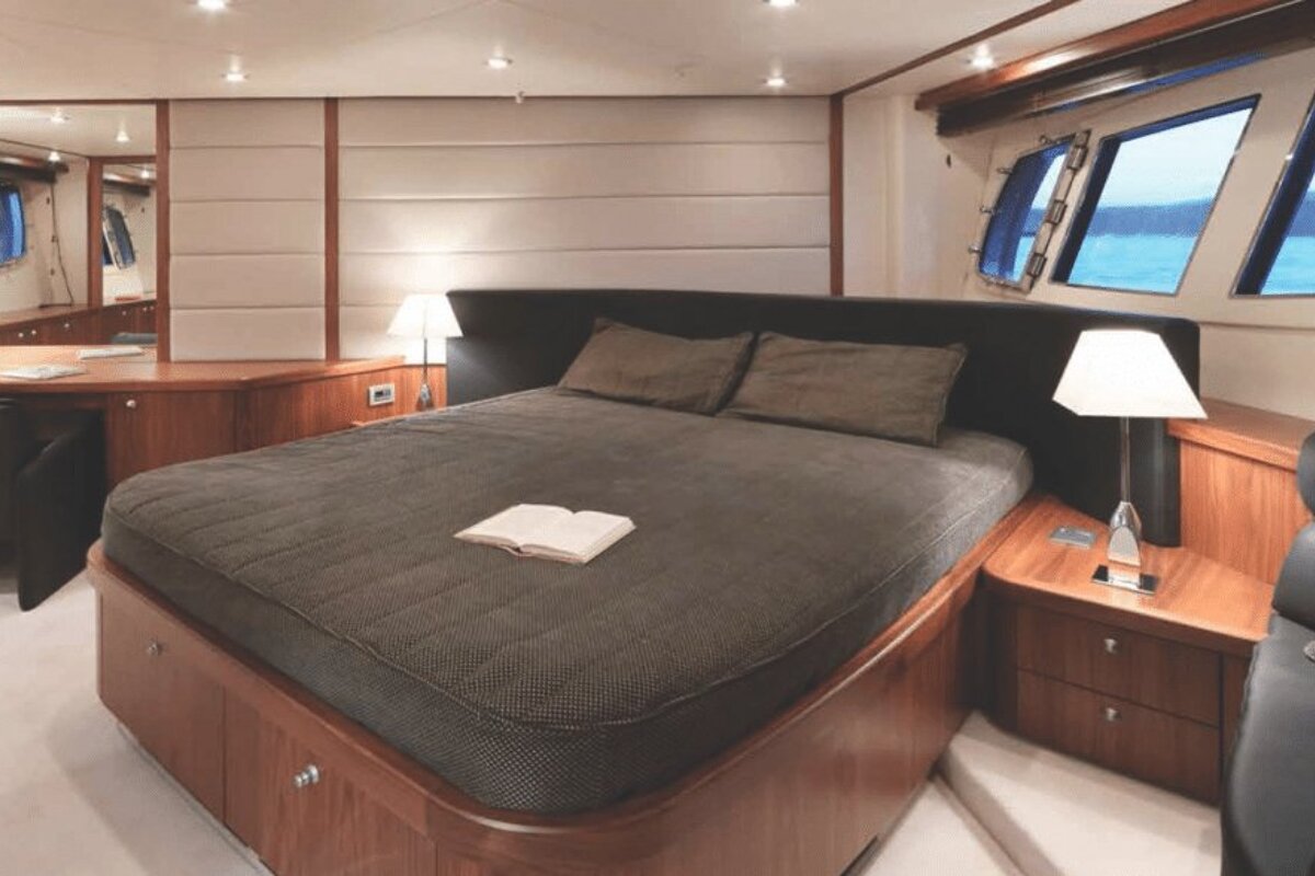 A bedroom with a large bed and a book on it