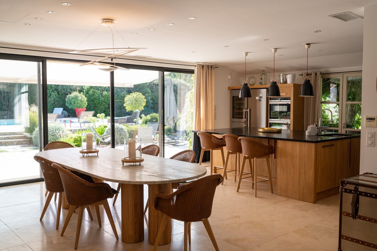 A kitchen with a table and chairs and a sliding glass door