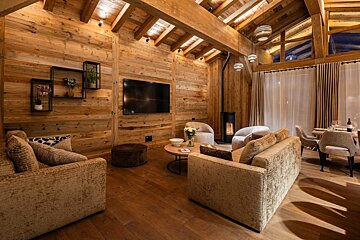 A living room with wooden walls and a flat screen tv