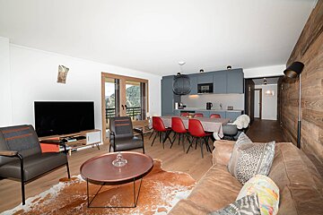 A living room with a couch a chair and a flat screen tv