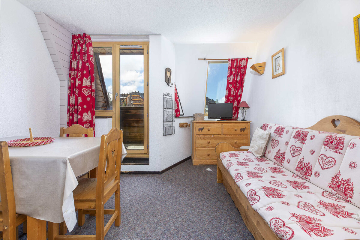 A living room with a couch a table and chairs