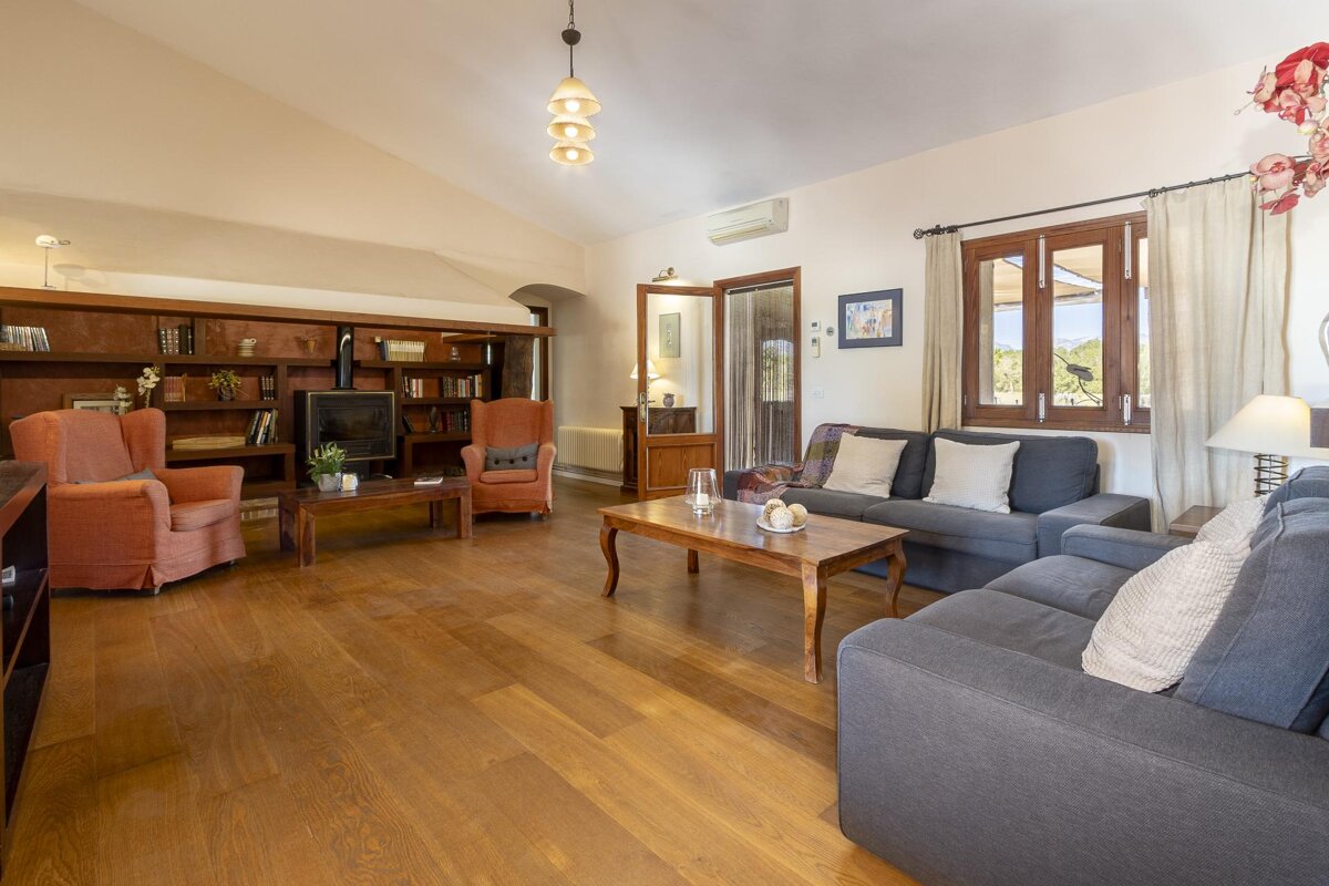 A living room with a couch and two chairs
