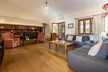 A living room with a couch and two chairs