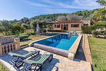 A house with a large swimming pool in front of it