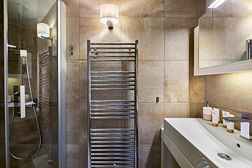 A bathroom with a towel rack and a sink