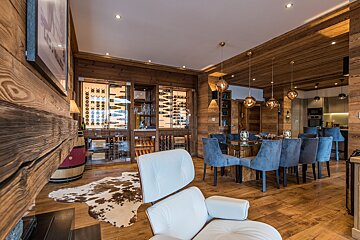 A living room with a chair and a wine cellar