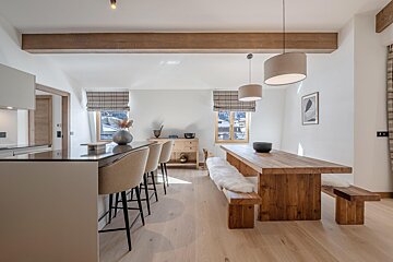 A dining room with a wooden table and benches