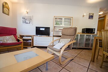 A living room with a chair a table and a television