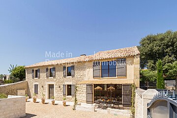 A large stone house with the words made in provence immobilier on it