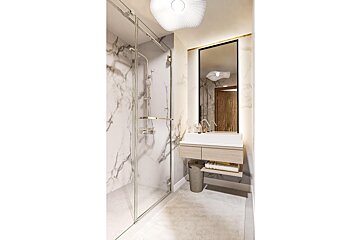A bathroom with a sink and a walk in shower