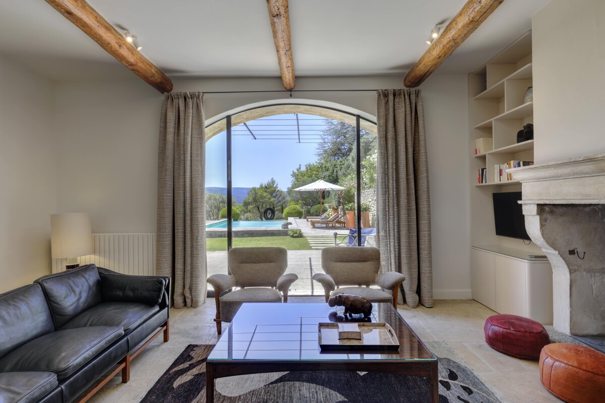 A living room with a couch and chairs and a fireplace