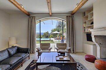 A living room with a couch and chairs and a fireplace