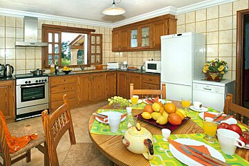 A kitchen with a table and chairs and a fridge that says ' bosch ' on it